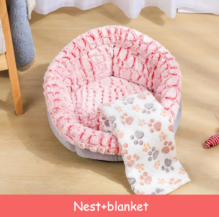 Pink plush pet bed with cat curled inside