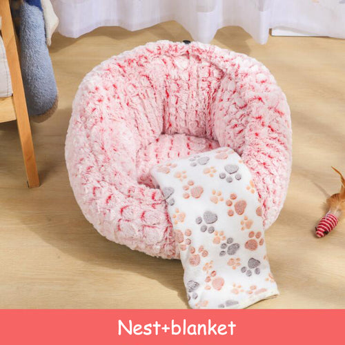 Pink plush pet bed with cat curled inside